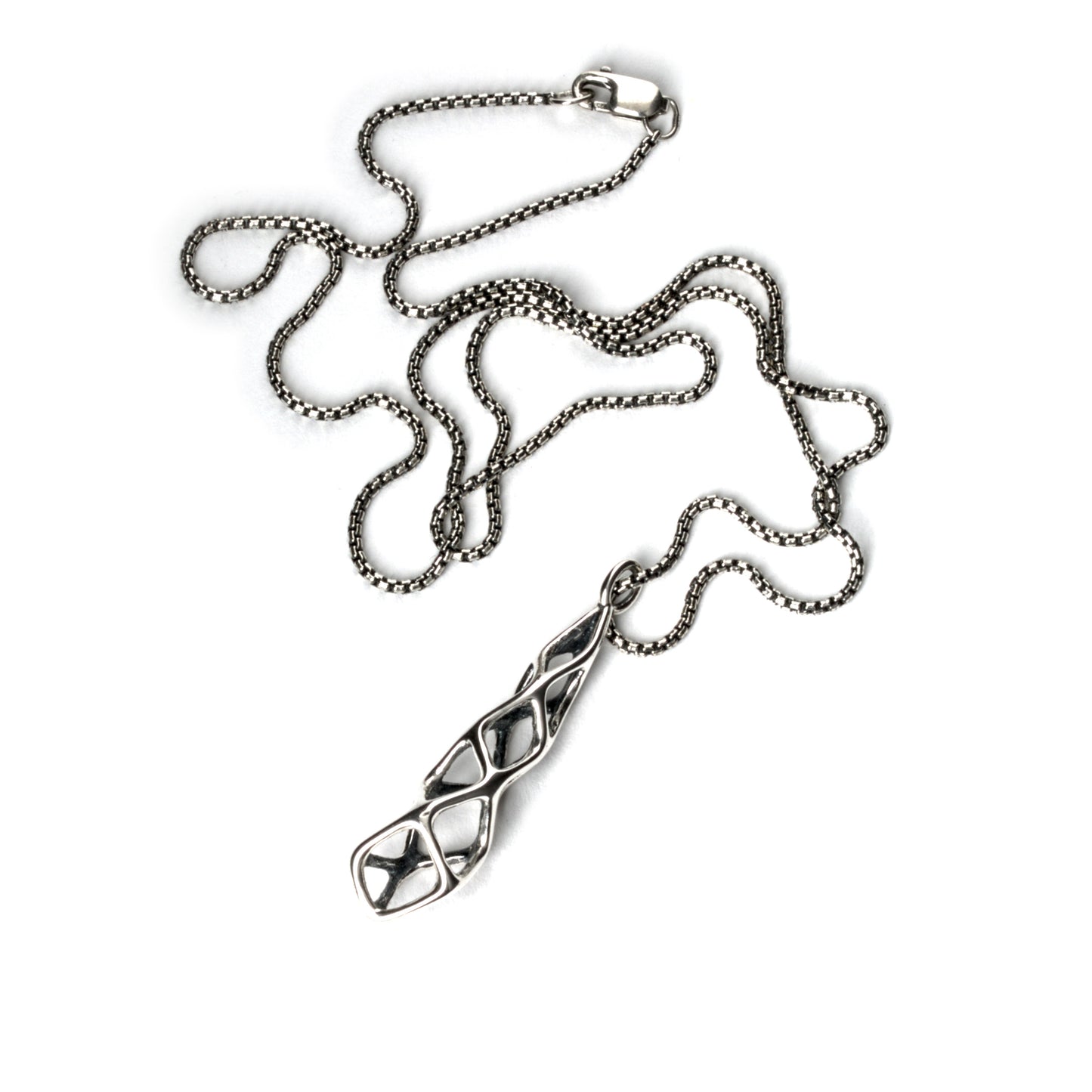 The contrast oxidized solid sterling geometric pendant is suspended from a matching box chain and finished with a lobster clasp.