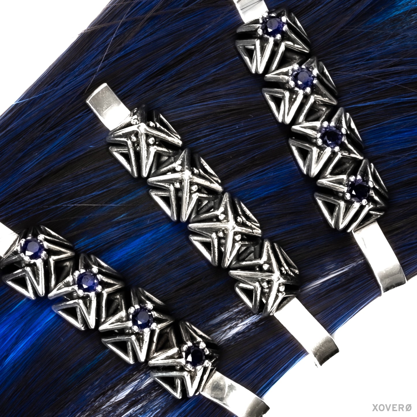Sterling silver spike topped bobby pin worn on blue hair with matching latticework bobby pins set with sapphire.
