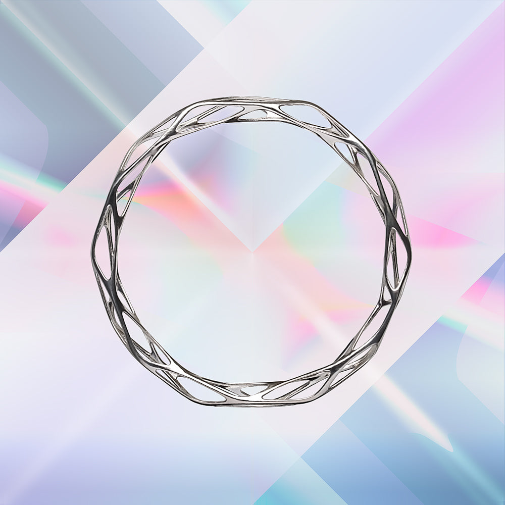The angular geometry of this solid sterling silver filigree bangle bracelet is dimensional and futuristic.