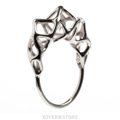 Side view of a dimensional sterling silver ring with geometric latticework crown. 