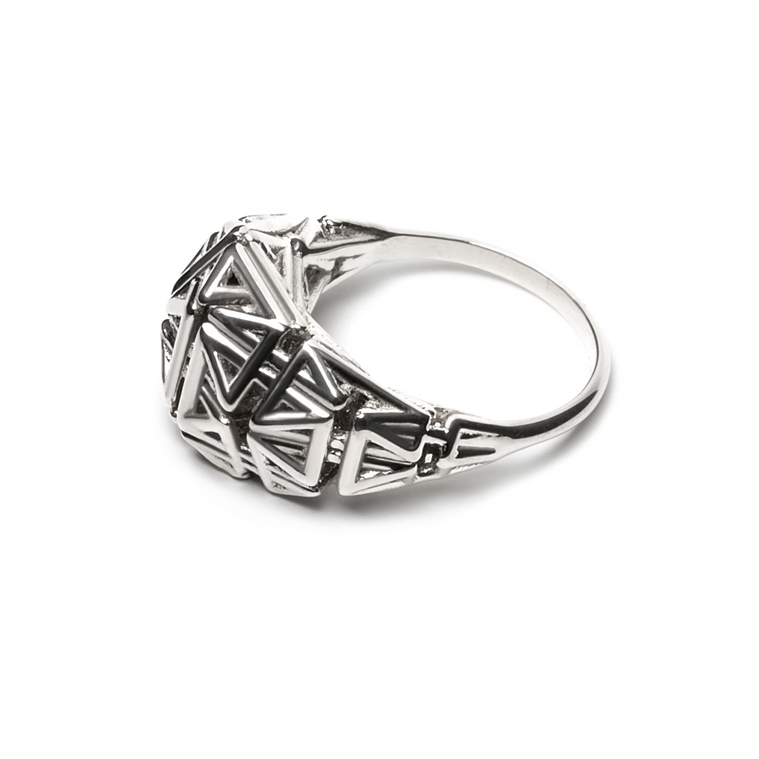 Side view of a sterling silver ring with a crown of angular latticework springing from a narrow band.