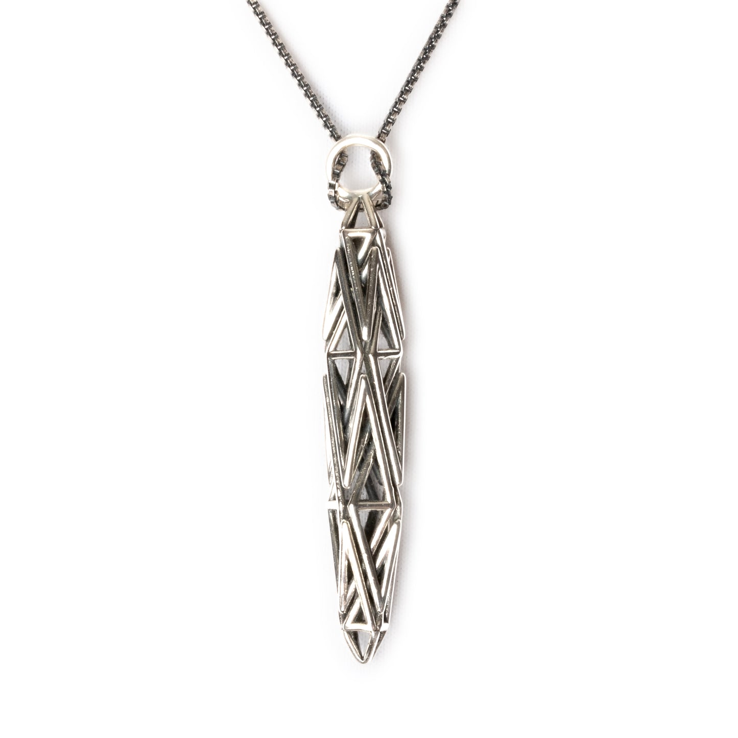 Sculptural sterling silver pendant with angular geometric latticework, inspired by High-Tech architecture and Art Deco geometry.