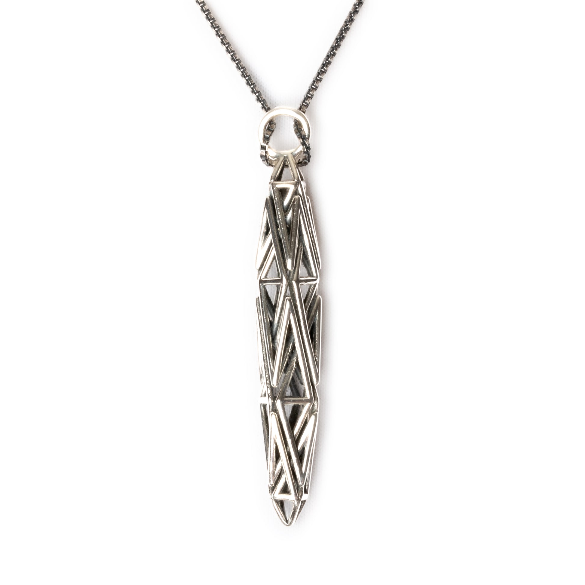 Sculptural sterling silver pendant with angular geometric latticework, inspired by High-Tech architecture and Art Deco geometry.