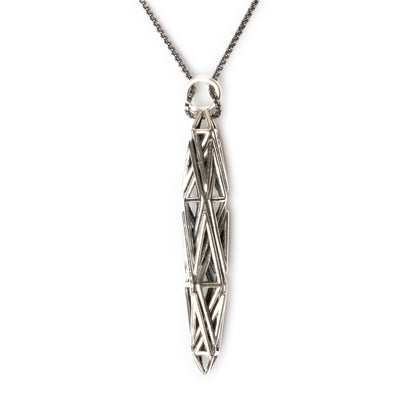 Sculptural sterling silver pendant with angular geometric latticework, inspired by High-Tech architecture and Art Deco geometry.