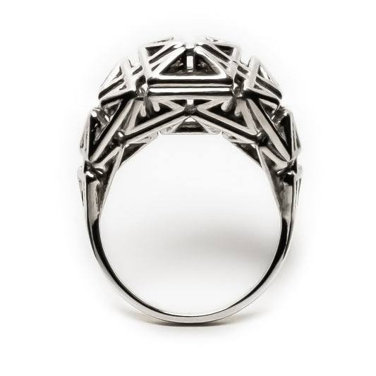 Sculptural unisex ring in solid .925 sterling silver with oxidized recesses and angular architectural latticework in a signet-like form.