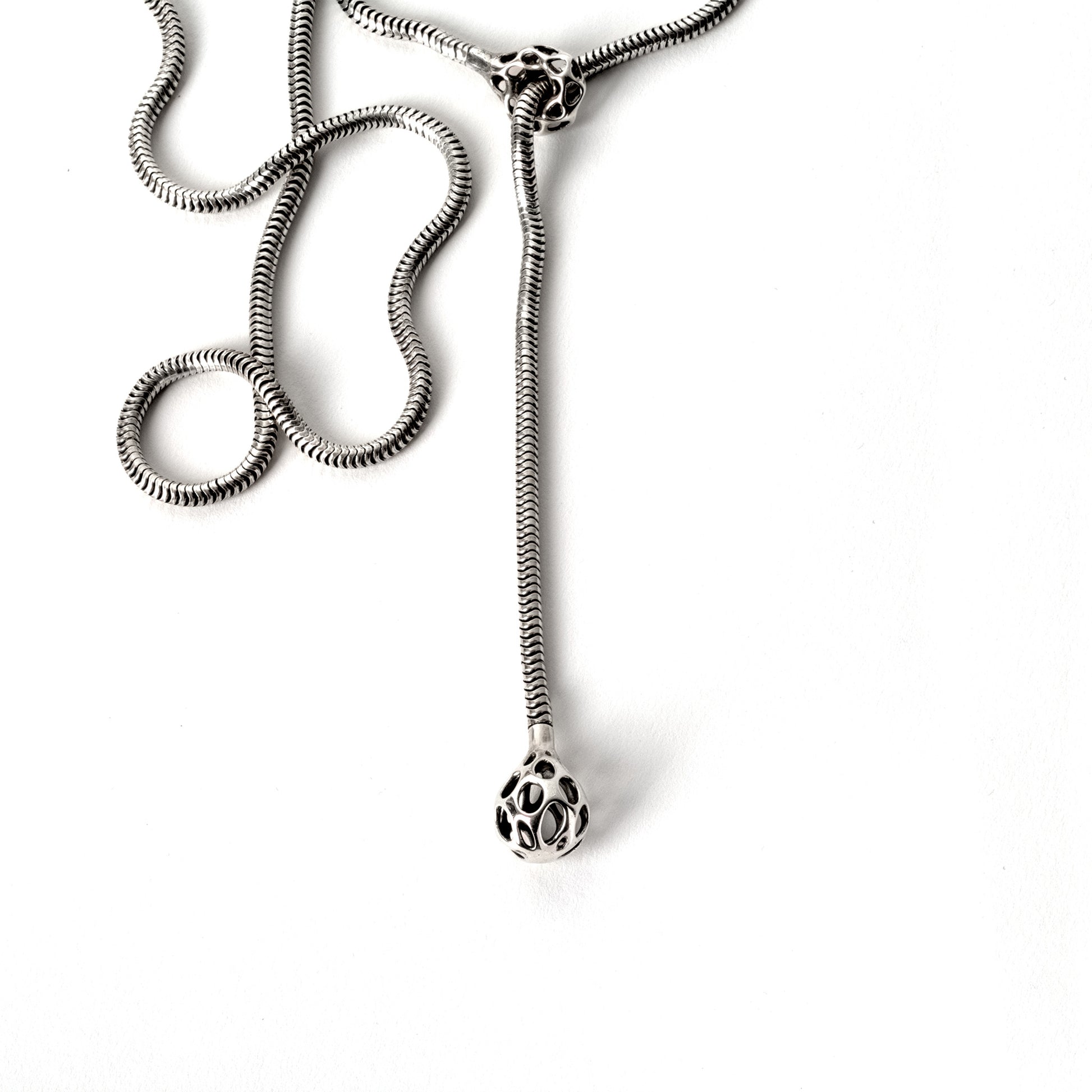 A sterling silver lariat necklace with a matching latticework droplet and cufflet hand-soldered to each end of a thick chunky snake chain. The bold sexy necklace drapes fluidly for a lightweight comfortable fit. 
