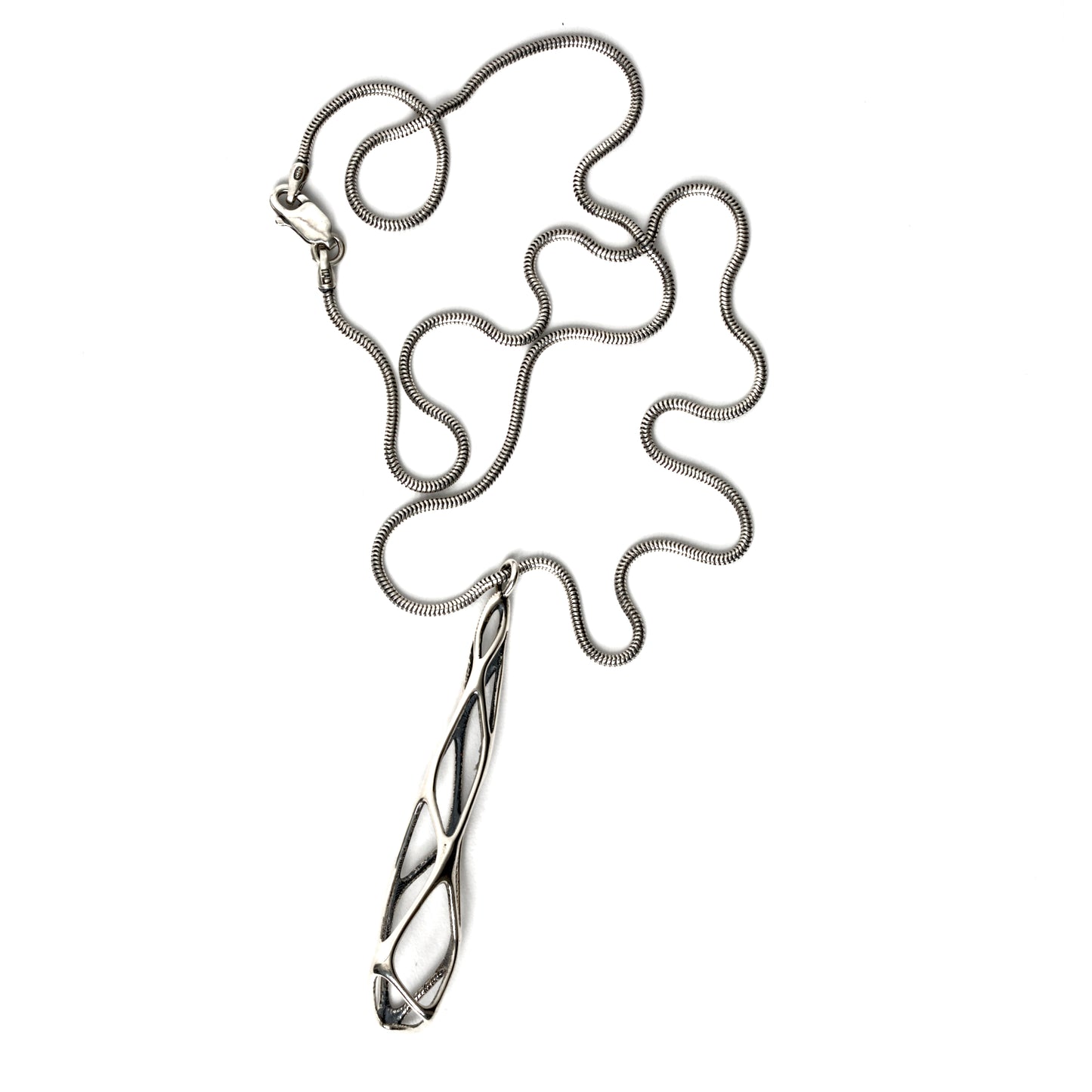 Solid sterling silver architectural pendant necklace with edgy elongated lattice suspended from a snake chain and secured with a lobster clasp. Contrast oxidation adds darkness and depth to recessed details. 