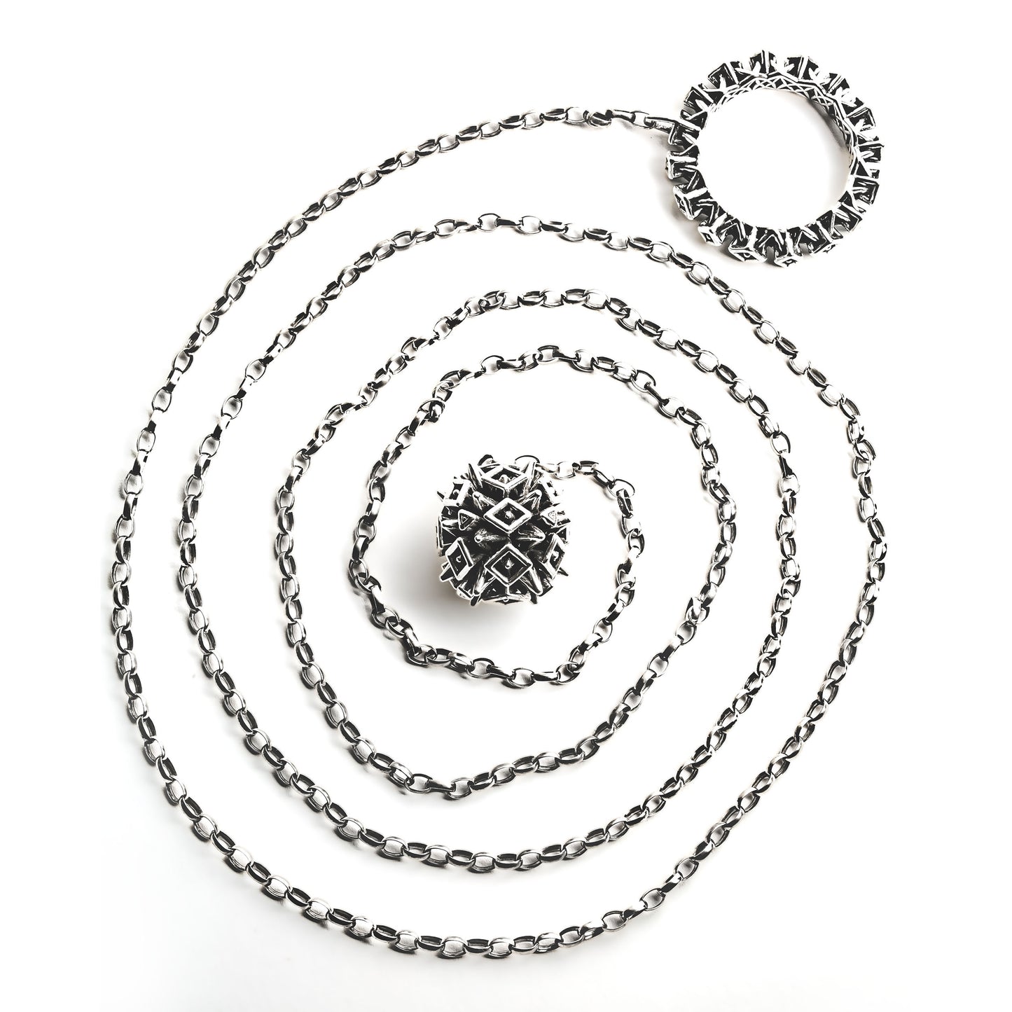 Chunky sterling silver lariat necklace with spiked ball and hoop hardware soldered to opposite ends of a thick 4-foot chain. Shown here coiled on white background, this modern sculptural jewelry is crafted for versatile styling and structured necklace stacking.