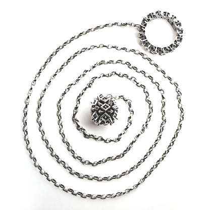 Chunky sterling silver lariat necklace with spiked ball and hoop hardware soldered to opposite ends of a thick 4-foot chain. Shown here coiled on white background, this modern sculptural jewelry is crafted for versatile styling and structured necklace stacking.