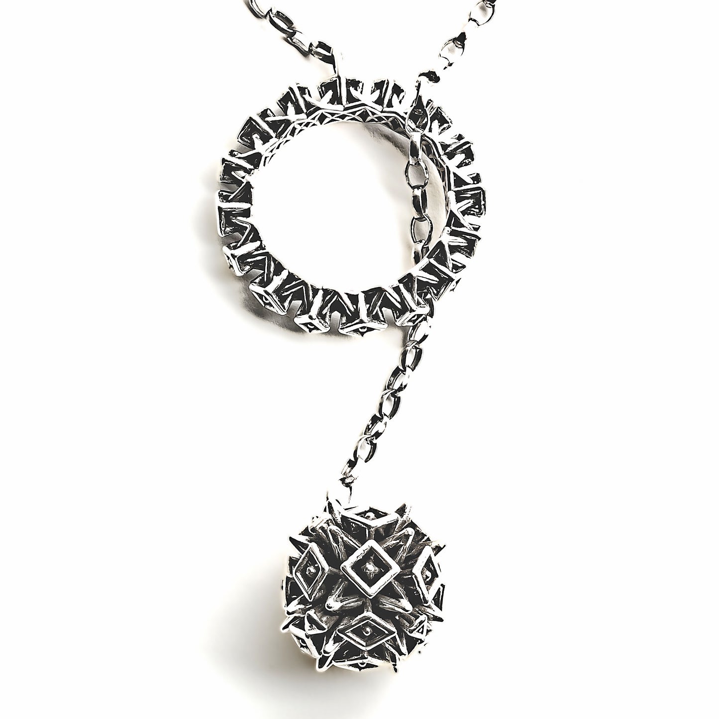 A solid .925 sterling silver lariat necklace with spiky ball and hoop closure is photographed on a white background. The spiked sphere is passed through the matching spiked hoop, locking the necklace in place. 