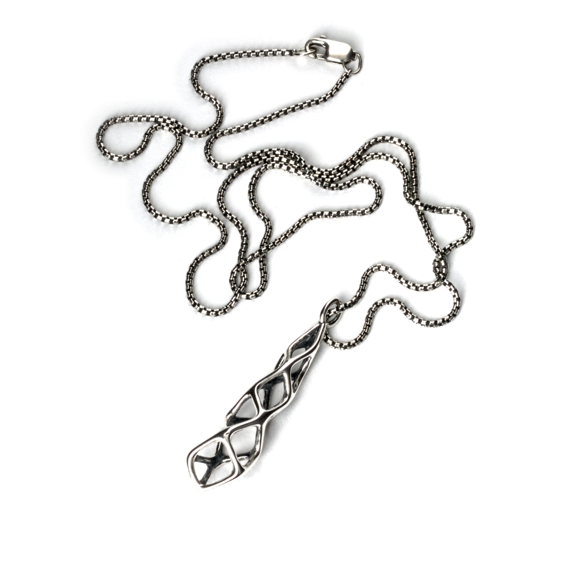 The contrast oxidized solid sterling geometric pendant is suspended from a matching box chain and finished with a lobster clasp. 