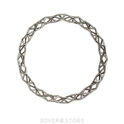 A sterling silver bangle bracelet with a highly polished dimensional lattice geometry. The delicate form is packed with light scattering detail. 