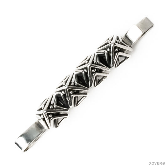 A sterling silver bobby pin with a geometric lattice of dense detailed angles forming pointed spikes.