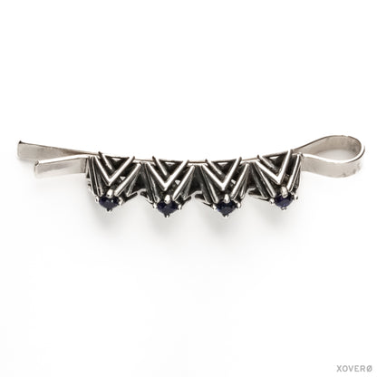 Art Deco-inspired heirloom bobby pin composed of an angular lattice of pyramid studs set with blue sapphires. 