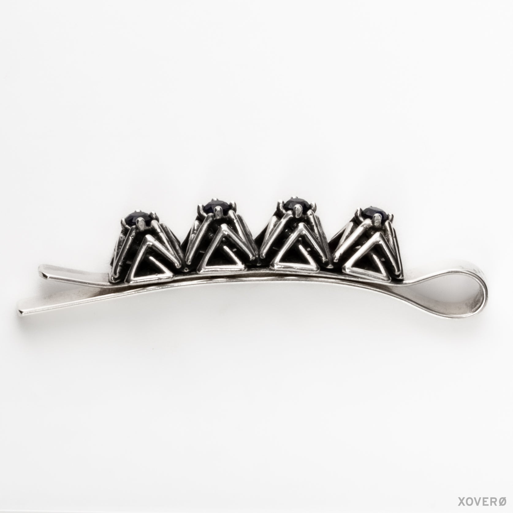 Xover0's solid sterling silver geometric lattice bobby pin with hand-set sapphires viewed from the side showing the design's proportions in clear detail. 