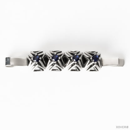 Architectural latticework bobby pin crafted from solid sterling silver with four hand-set blue sapphires. 