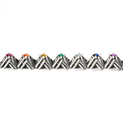Side view of the solid .925 bar pendant with rainbow gemstones. This photo shows the dimension of the complex stud settings. Each pyramid spike measures about 1x1x1  cm. 