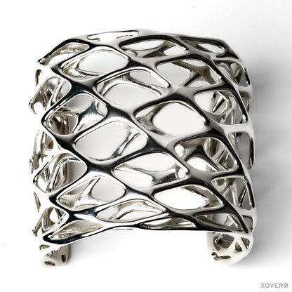 Tall dimensional sterling silver cuff bracelet with fluid angular lattice design. 