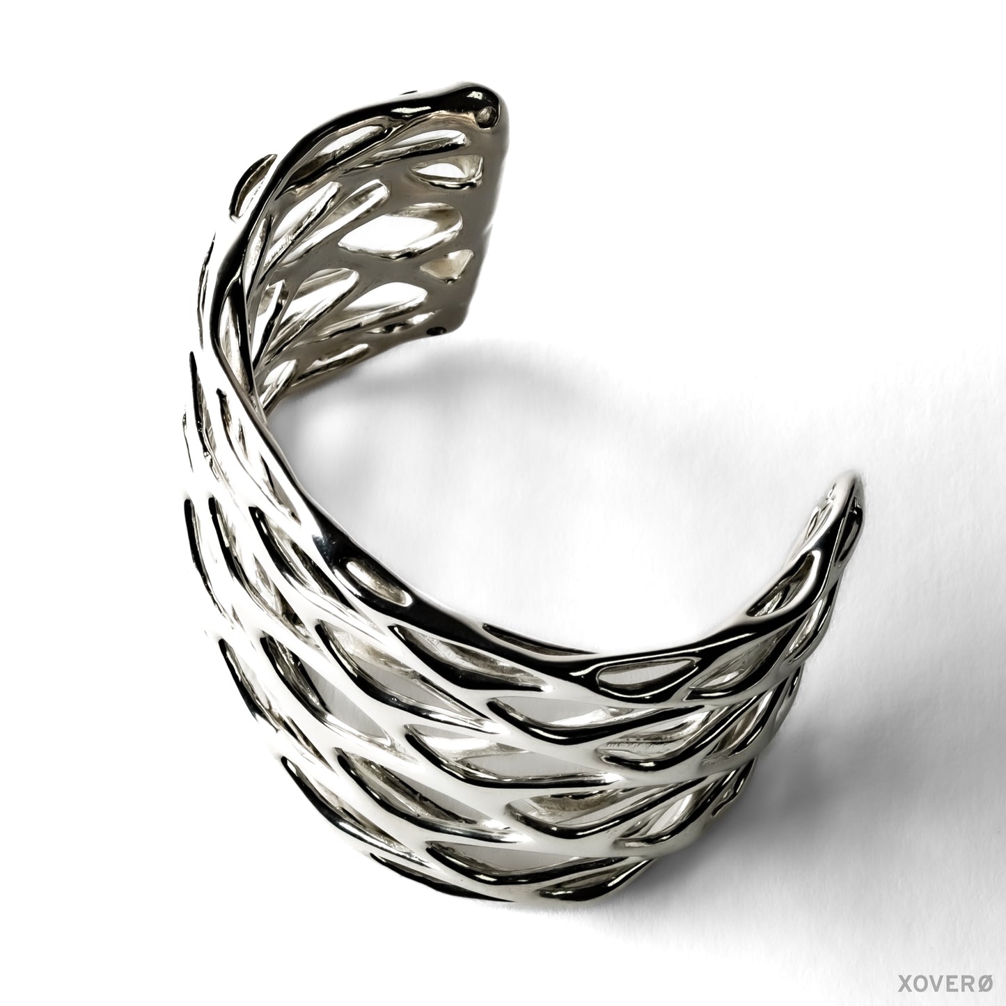 Thick chunky latticework cuff bracelet crafted from solid sterling silver. The smooth fluid lattice is sculpted into a wrist shaped arc. 