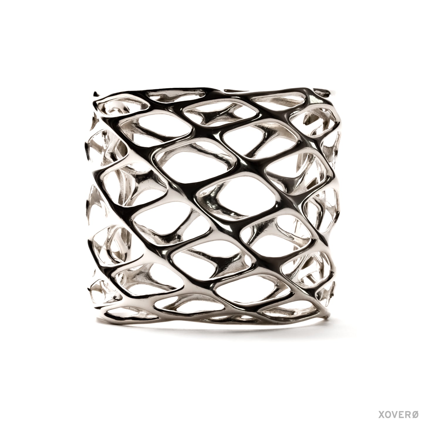 A tall, chunky sterling silver cuff bracelet with a layered geometric lattice pattern. The statement accessory has an angular edgy aesthetic. 