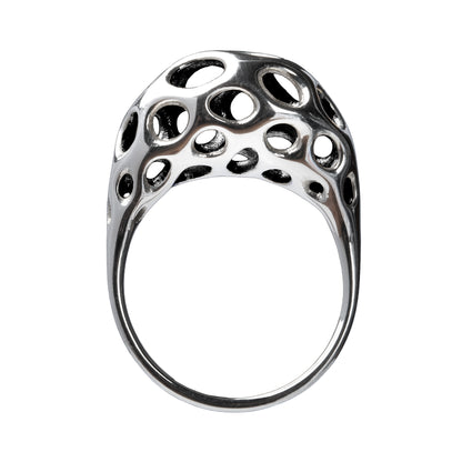 A sterling silver ring with a sculptural, crescent-shaped dome featuring intricate oval cutouts, displayed against a white background.