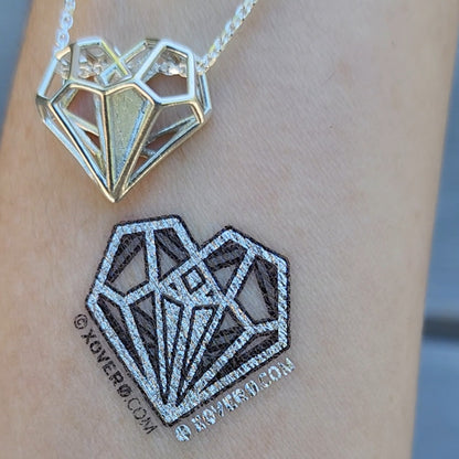 High quality metallic silver temporary tattoos of Tally's Heart Pendant from Netflix's Uglies movie. This design stands out equally well on all skin tones. Seen here on pale skin. 