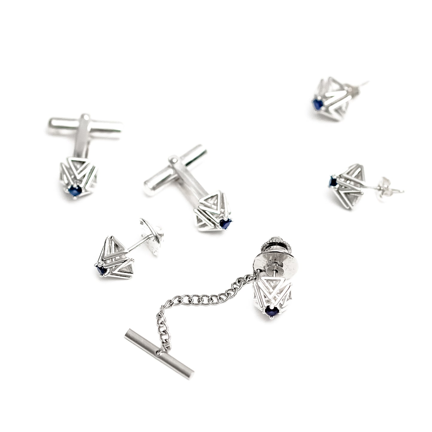This pair of sapphire and solid sterling silver cuff links is part of a collection that includes a matching tie tack, and earrings, all shown here on a white background. 