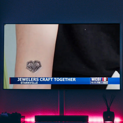 WCBI News story on Xover0 jewelry. This shot shows the Geoheart temporary tattoo based on the necklace Joey King wore in Netflix's Uglies. 
