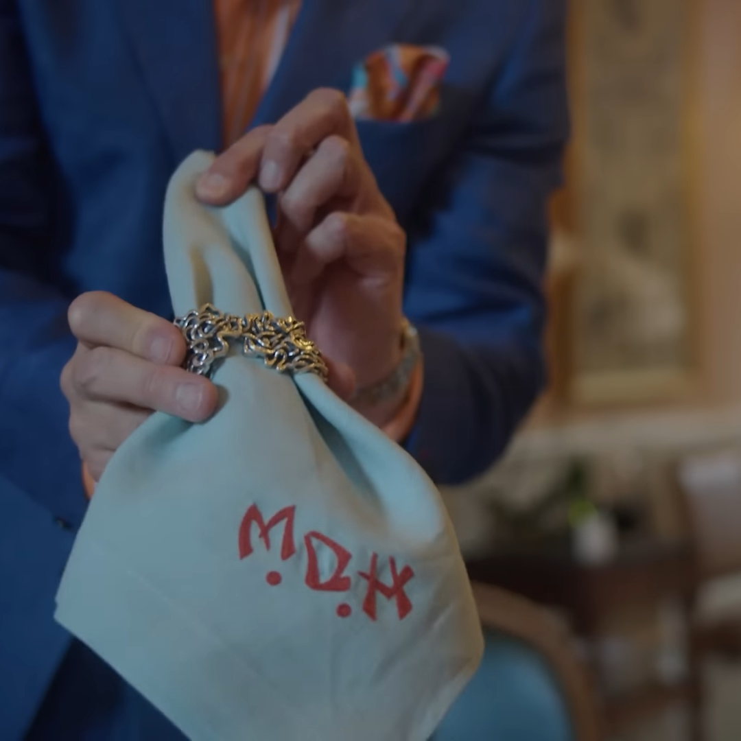Xover0���s solid sterling silver Mississippi River Napkin Ring held by a man in a blue suit from the Homeworthy episode ���HOUSE PARTY TOUR | Inside a Glamorous Progressive Dinner in New Orleans."