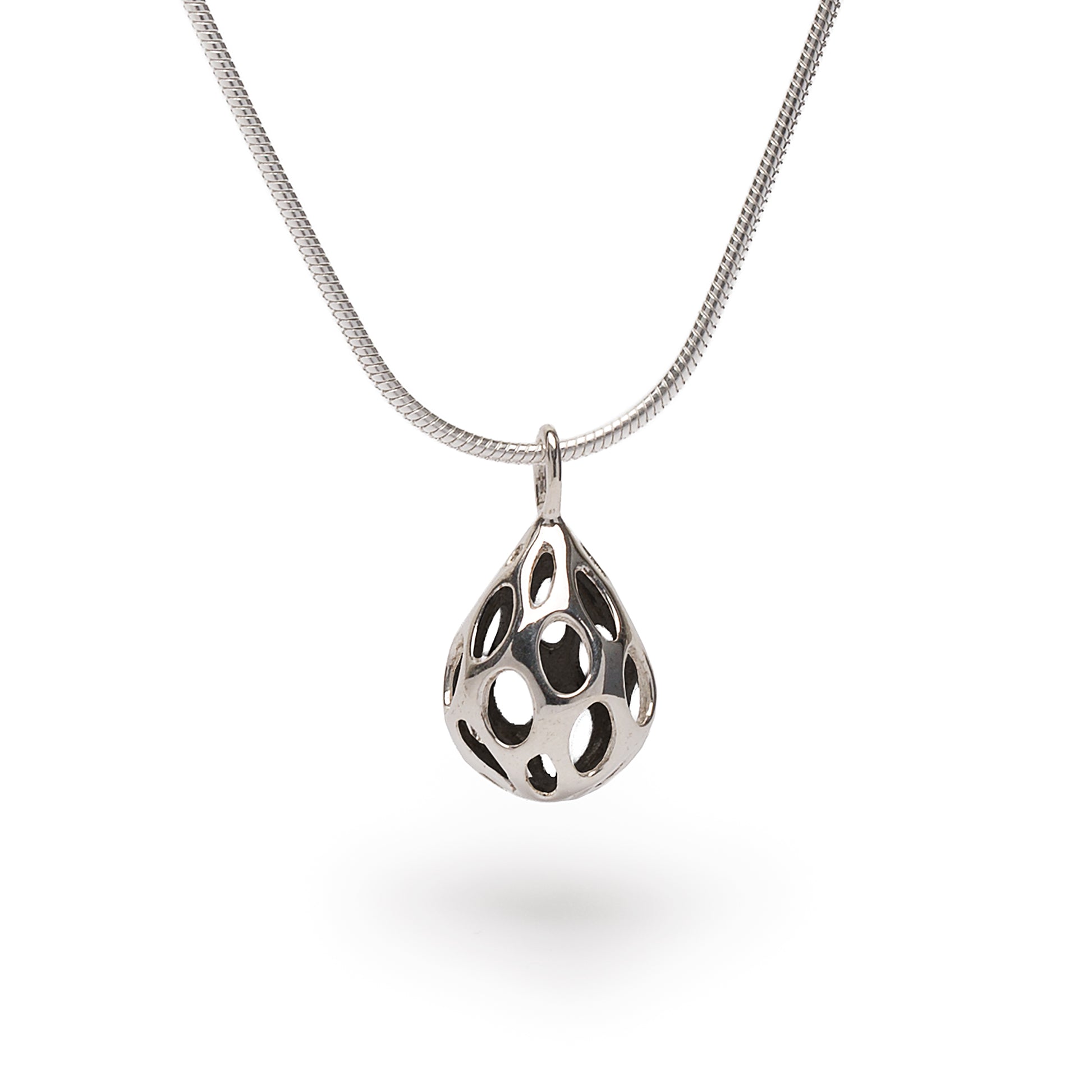 Polished sterling silver OLEA pendant necklace by Xover0, featuring a dimensional teardrop shape pierced with oval cutouts. Suspended from an 18-inch liquid silver snake chain, this minimalist, raindrop-inspired design reflects light with every movement.