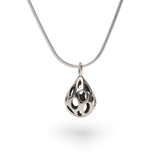 Polished sterling silver OLEA pendant necklace by Xover0, featuring a dimensional teardrop shape pierced with oval cutouts. Suspended from an 18-inch liquid silver snake chain, this minimalist, raindrop-inspired design reflects light with every movement.