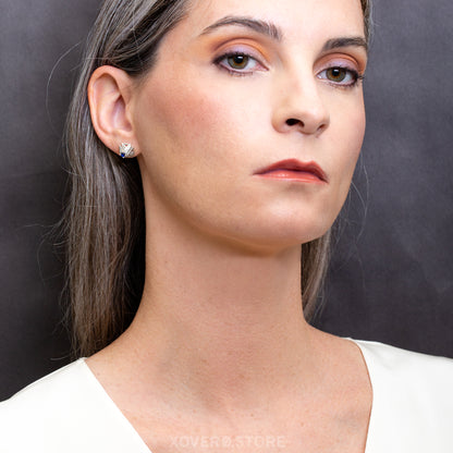 Angular lattice stud earrings in sterling silver with sapphire setting styled as an edgy accent to a starkly styled look. 