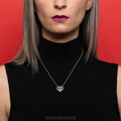 The Geoheart Pendant necklace modeled, showcasing its adjustable chain worn at a longer length. It can be adjusted up to 18 inches, the length at which Joey King wears it as Tally Youngblood in the Netflix movie Uglies. This solid .925 sterling silver heart pendant features a futuristic take on Art Deco design, reflecting the iconic, heirloom-quality craftsmanship of Xover0 Jewelry.