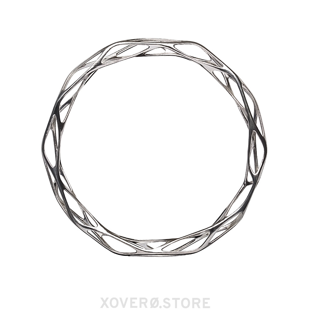 A sterling silver bangle bracelet with a futuristic filigree pattern, designed to be worn on the wrist.