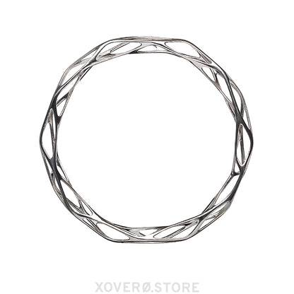 A sterling silver bangle bracelet with a futuristic filigree pattern, designed to be worn on the wrist.