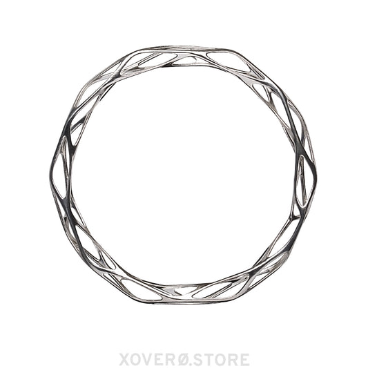 A sterling silver bangle bracelet with a futuristic filigree pattern, designed to be worn on the wrist.